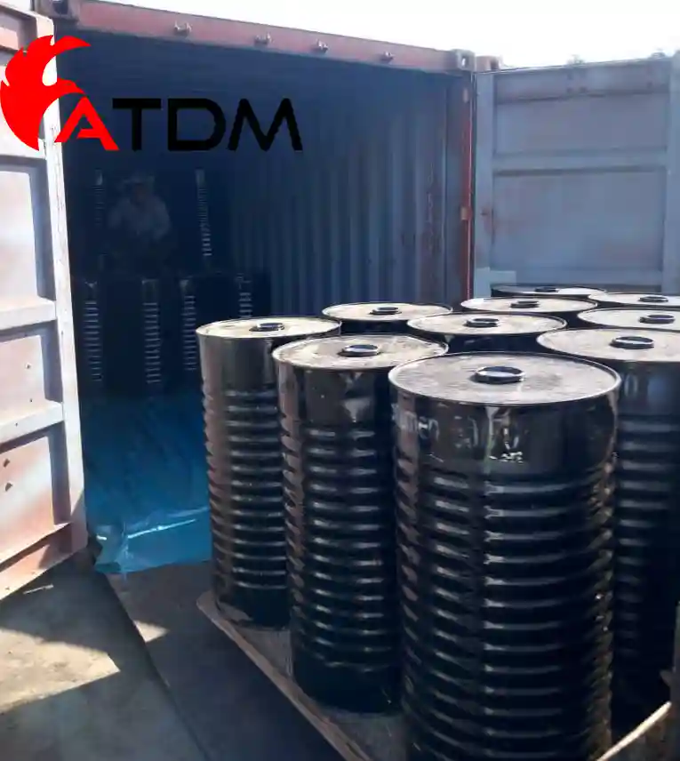 High-viscosity Bitumen 10/20 packed in new steel drums and loaded in export containers for road construction and industrial use.